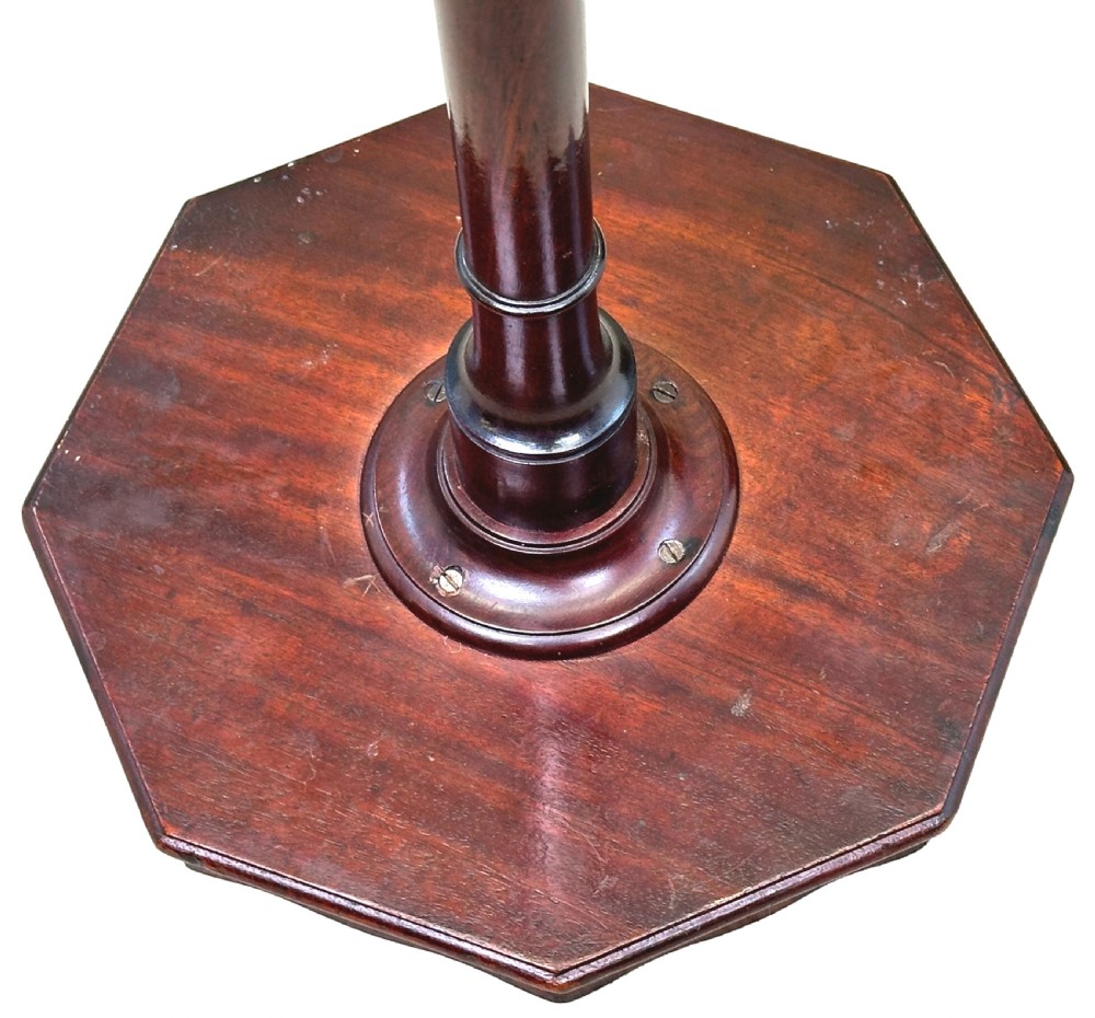 A tall George III mahogany torchere candle stand featuring a scalloped gallery top, turned column shaft, and splayed tripod legs. View VII