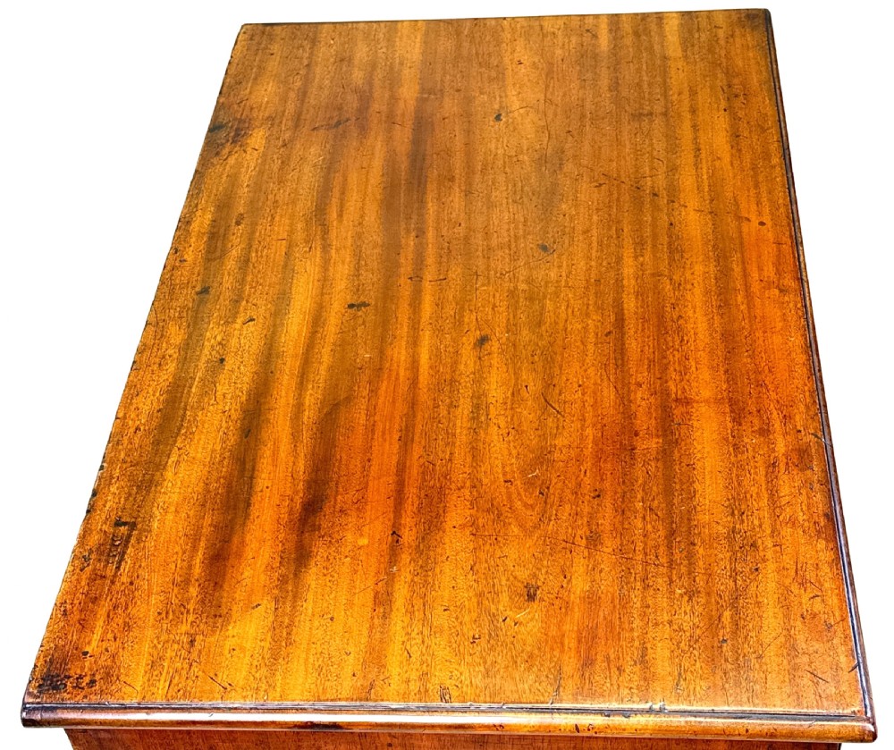 A Georgian mahogany chest of drawers featuring four graduated drawers, a pull-out brushing slide, brass swan-neck handles, and bracket feet. View III