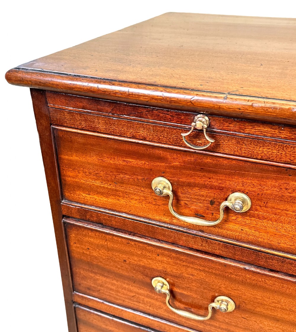 A Georgian mahogany chest of drawers featuring four graduated drawers, a pull-out brushing slide, brass swan-neck handles, and bracket feet. View VIII