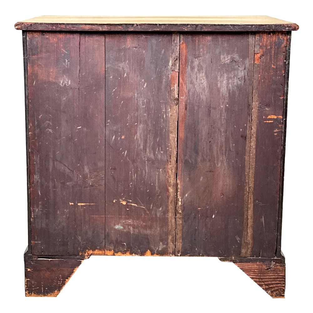 A Georgian mahogany chest of drawers featuring four graduated drawers, a pull-out brushing slide, brass swan-neck handles, and bracket feet. View XI