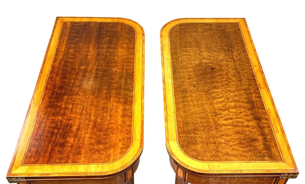 A pair of late Georgian mahogany fold-over card tables featuring satinwood crossbanding and square tapered legs. View II