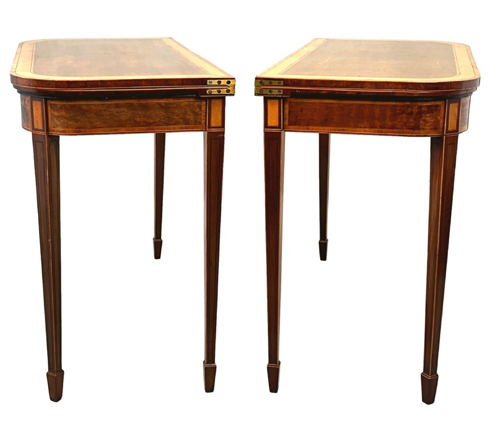 A pair of late Georgian mahogany fold-over card tables featuring satinwood crossbanding and square tapered legs. View III