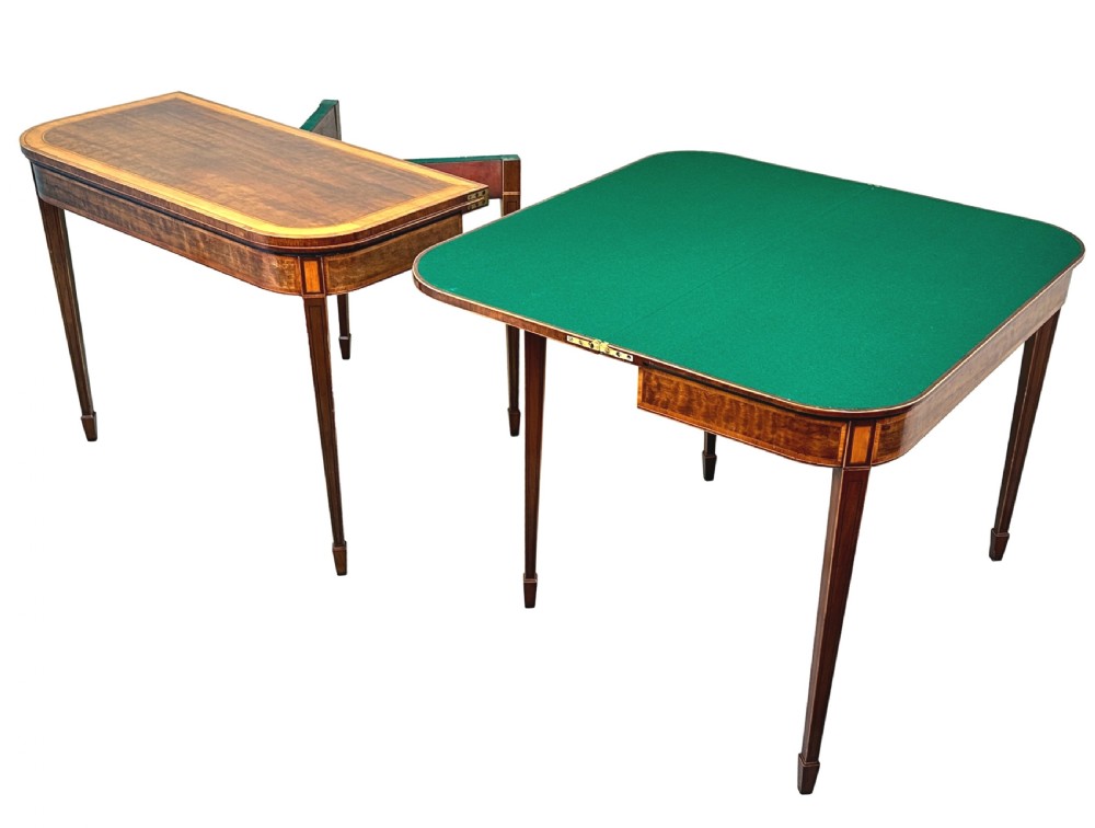 A pair of late Georgian mahogany fold-over card tables featuring satinwood crossbanding and square tapered legs. View IV