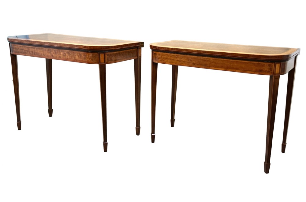 A pair of late Georgian mahogany fold-over card tables featuring satinwood crossbanding and square tapered legs. View V