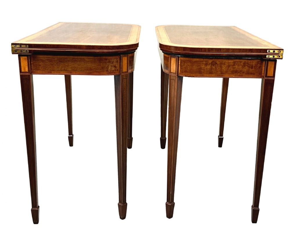 A pair of late Georgian mahogany fold-over card tables featuring satinwood crossbanding and square tapered legs. View VIII