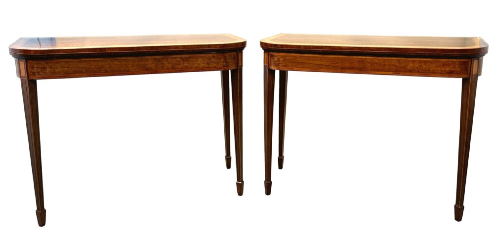 A pair of late Georgian mahogany fold-over card tables featuring satinwood crossbanding and square tapered legs. View XV