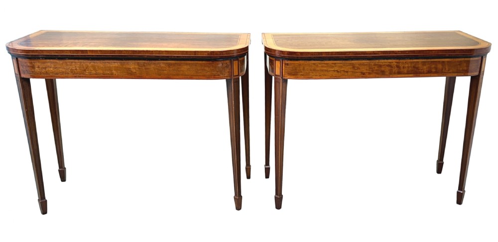 A pair of late Georgian mahogany fold-over card tables featuring satinwood crossbanding and square tapered legs. View XVI
