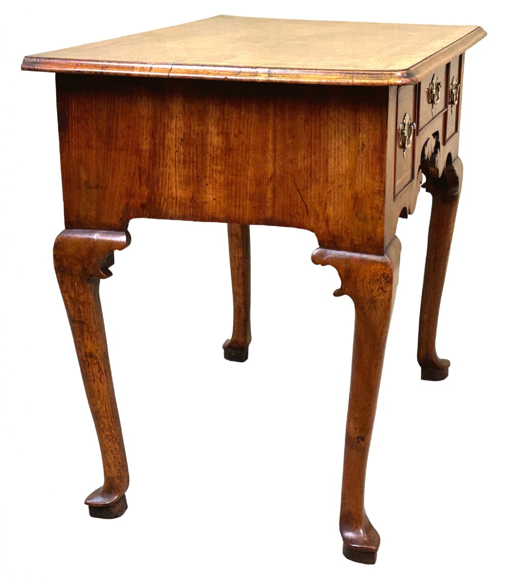 An 18th-century Georgian walnut lowboy table with three drawers, brass drop handles, a carved apron, and cabriole legs. View IV