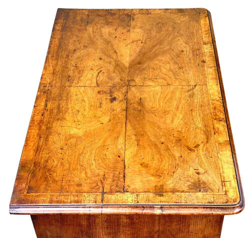 An 18th-century Georgian walnut lowboy table with three drawers, brass drop handles, a carved apron, and cabriole legs. View VII