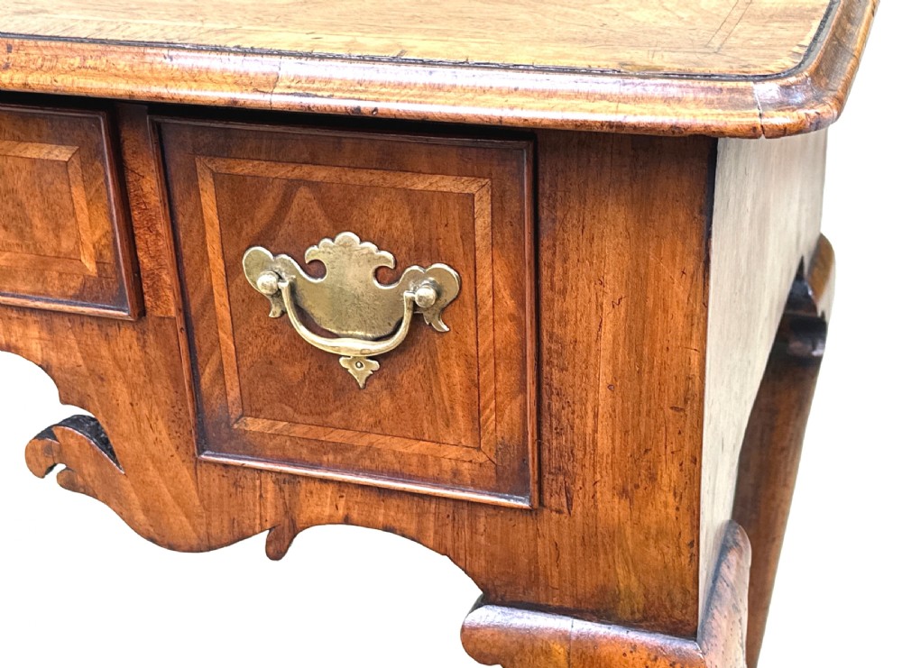 An 18th-century Georgian walnut lowboy table with three drawers, brass drop handles, a carved apron, and cabriole legs. View VIII