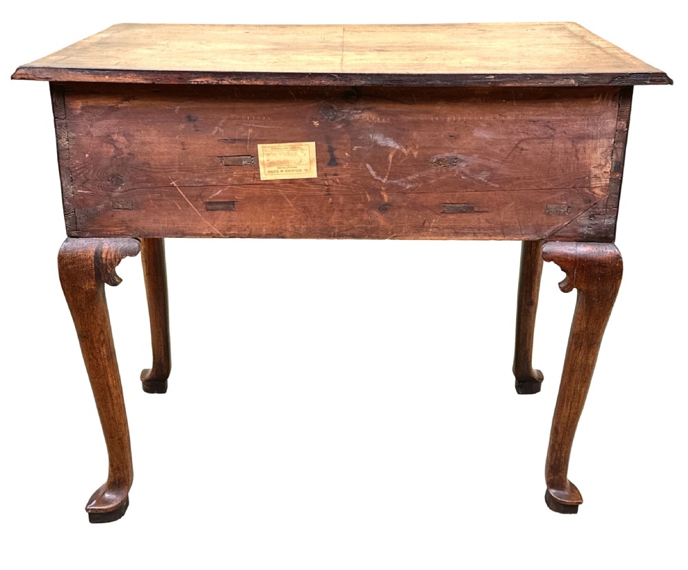 An 18th-century Georgian walnut lowboy table with three drawers, brass drop handles, a carved apron, and cabriole legs. View XIII