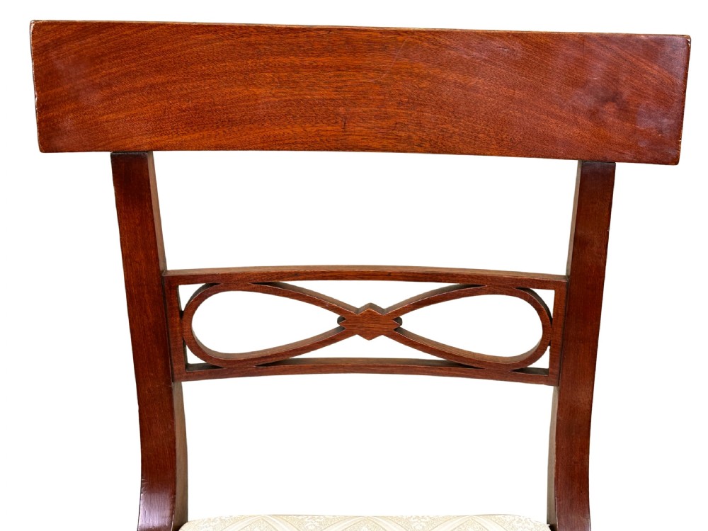 A set of eight Georgian mahogany dining chairs, including two carver armchairs and six side chairs, with pale patterned upholstered seats. View III