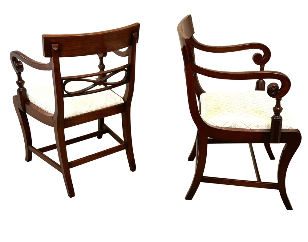 A set of eight Georgian mahogany dining chairs, including two carver armchairs and six side chairs, with pale patterned upholstered seats. View XI