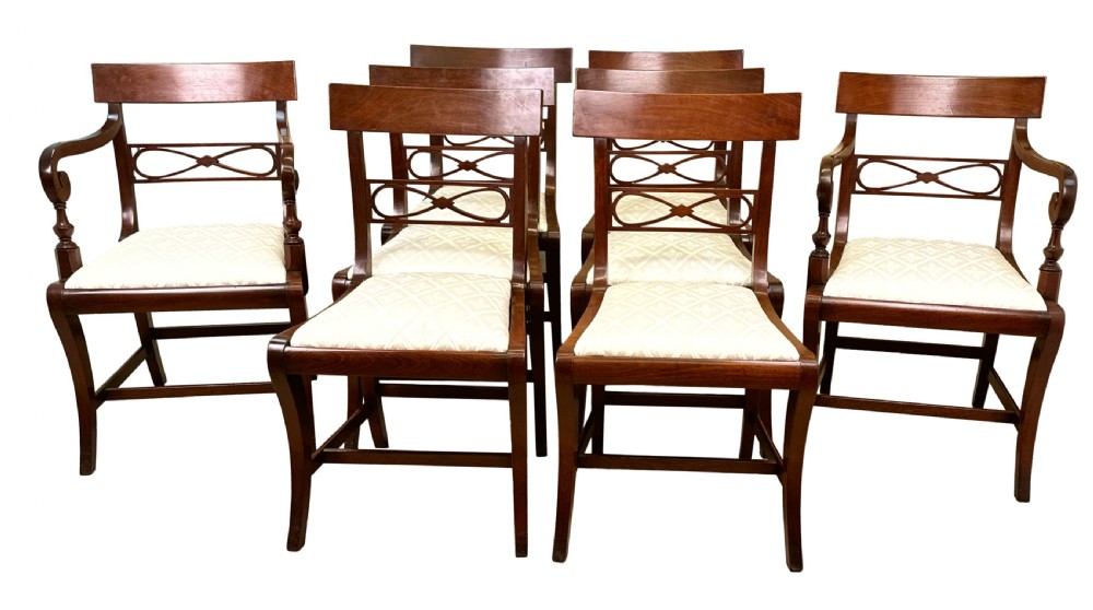 A set of eight Georgian mahogany dining chairs, including two carver armchairs and six side chairs, with pale patterned upholstered seats. View XII