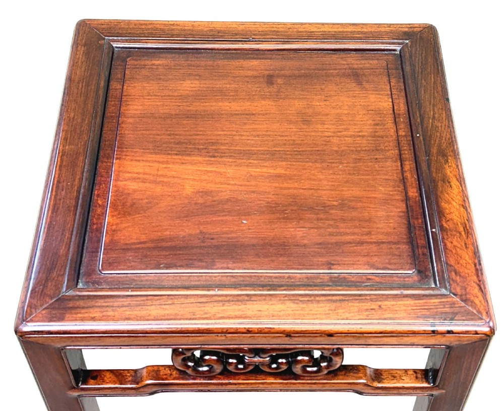 A dark brown square oriental hardwood side table featuring carved scrollwork aprons and straight legs with carved feet. View II
