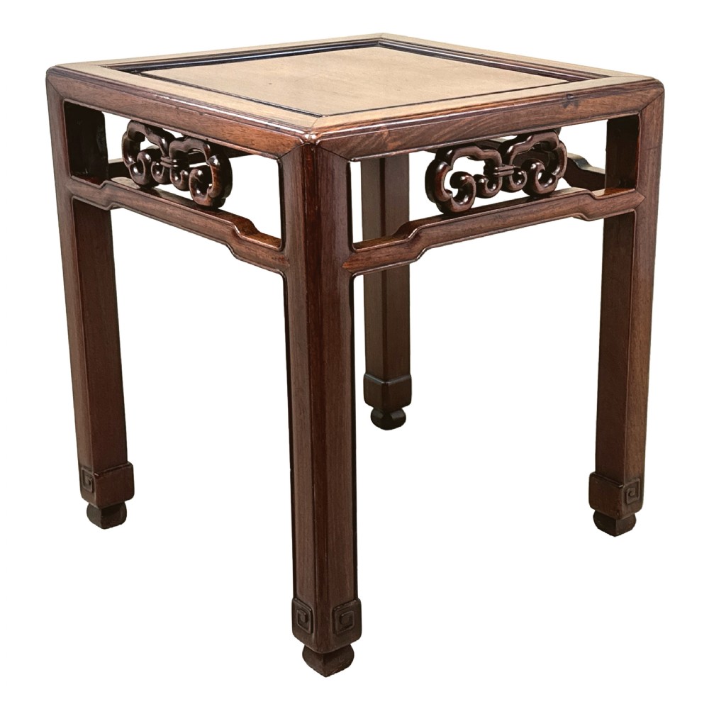 A dark brown square oriental hardwood side table featuring carved scrollwork aprons and straight legs with carved feet. View III