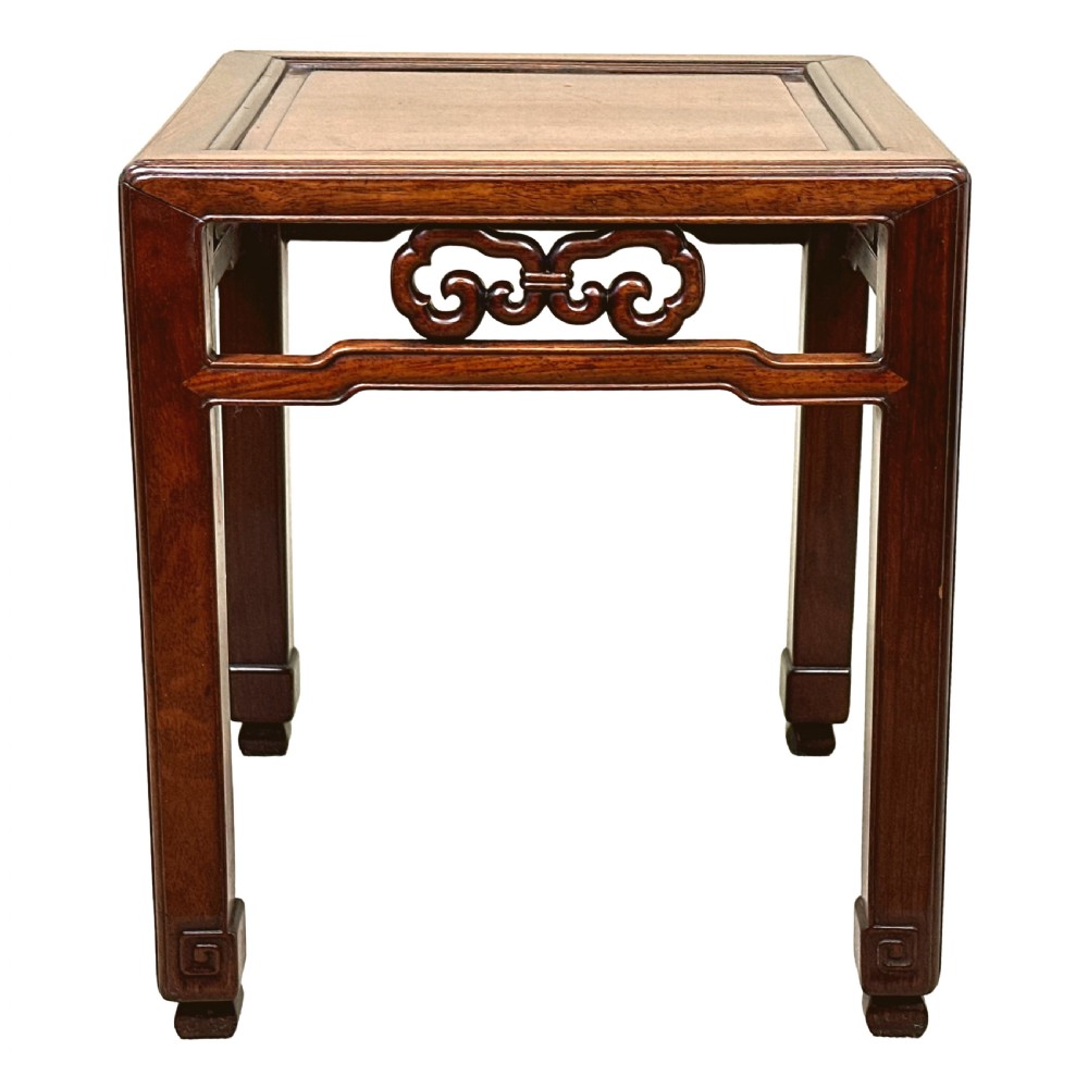 A dark brown square oriental hardwood side table featuring carved scrollwork aprons and straight legs with carved feet. View X