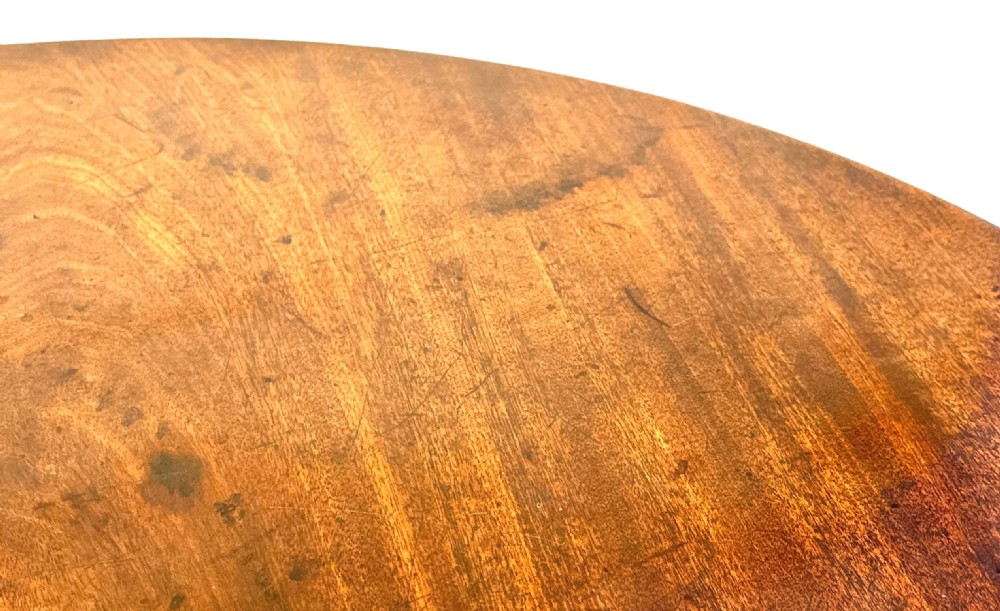 An 18th-century Georgian mahogany tripod table featuring a circular top, turned central column, and three cabriole legs with pad feet. View V