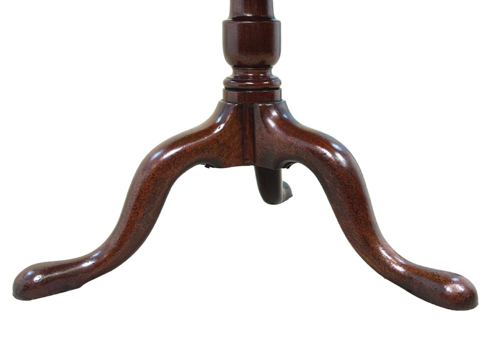 An 18th-century Georgian mahogany tripod table featuring a circular top, turned central column, and three cabriole legs with pad feet. View VI