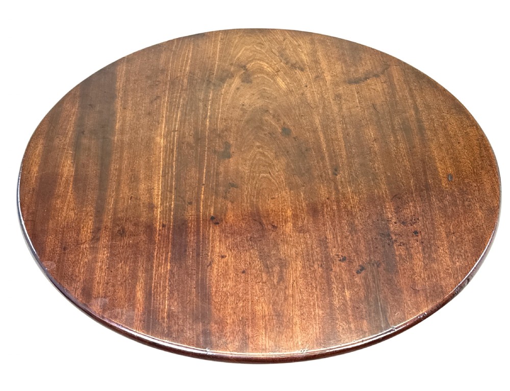 An 18th-century Georgian mahogany tripod table featuring a circular top, turned central column, and three cabriole legs with pad feet. View VII