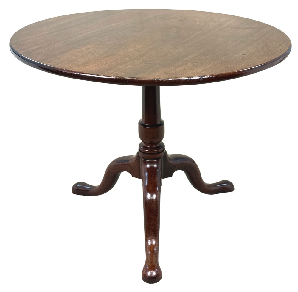 An 18th-century Georgian mahogany tripod table featuring a circular top, turned central column, and three cabriole legs with pad feet. View X