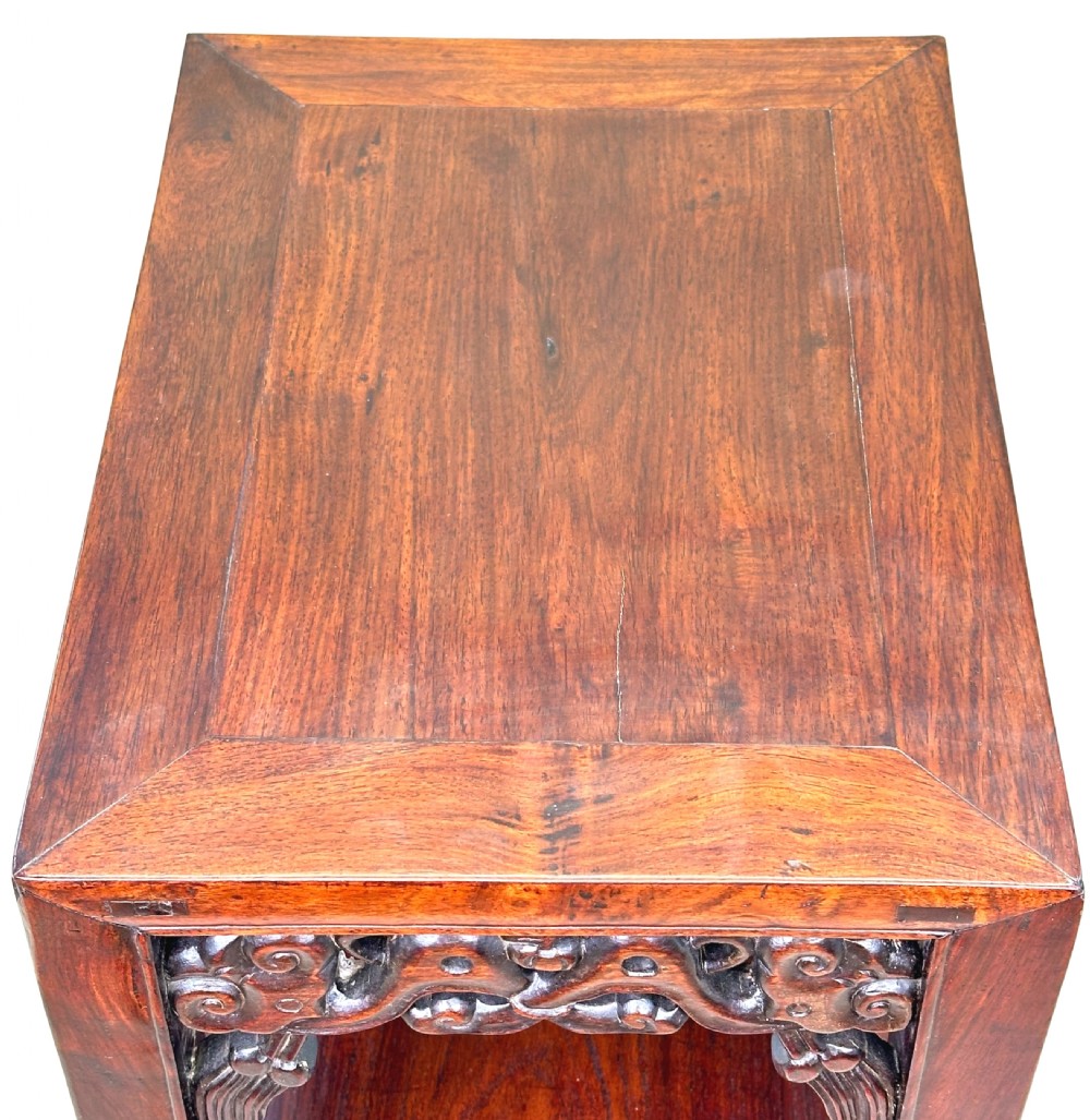 A tall, dark hardwood two-tier table featuring openwork carved aprons and straight square legs. View II