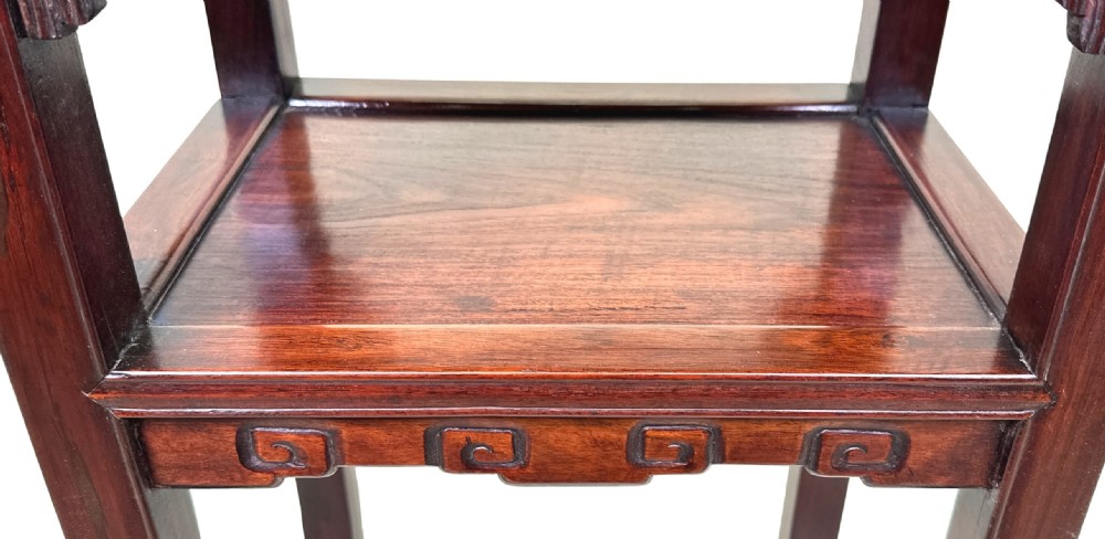 A tall, dark hardwood two-tier table featuring openwork carved aprons and straight square legs. View VI