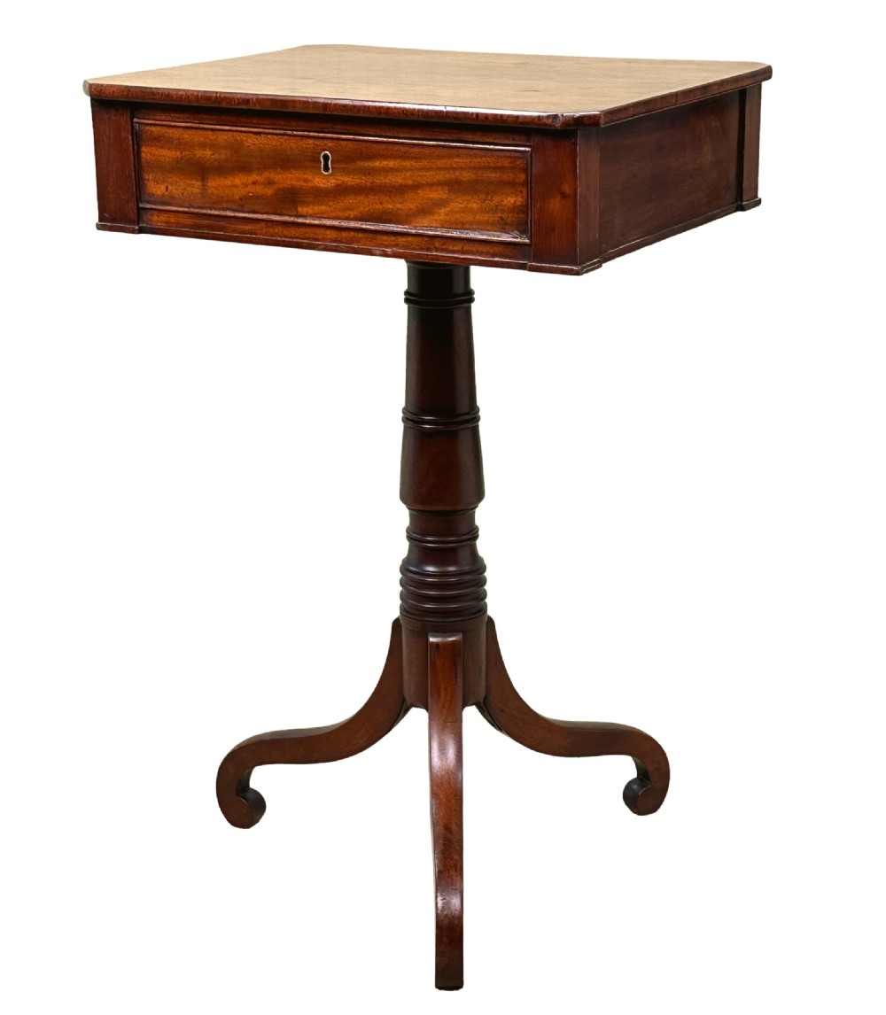 A Georgian mahogany side table featuring a rectangular top with a single drawer, supported by a central turned pedestal stem and a tripod base.