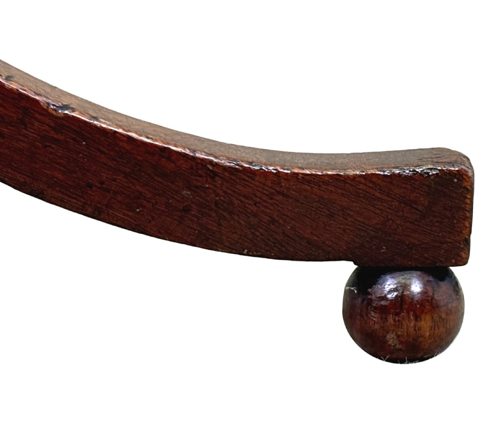 A Georgian mahogany wine table featuring a circular top elevated on a turned central pedestal stem with three splayed tripod legs. View II