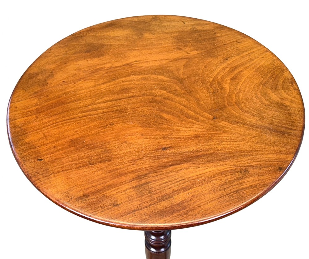 A Georgian mahogany wine table featuring a circular top elevated on a turned central pedestal stem with three splayed tripod legs. View IV