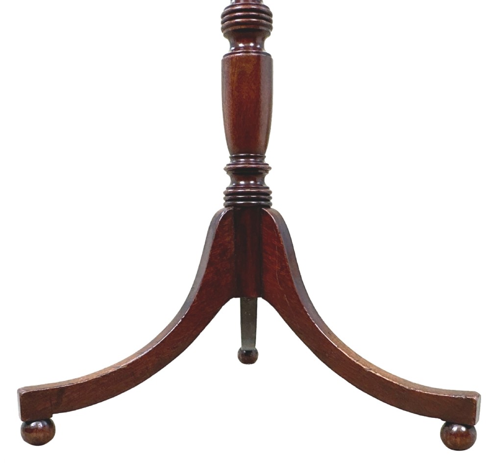 A Georgian mahogany wine table featuring a circular top elevated on a turned central pedestal stem with three splayed tripod legs. View V