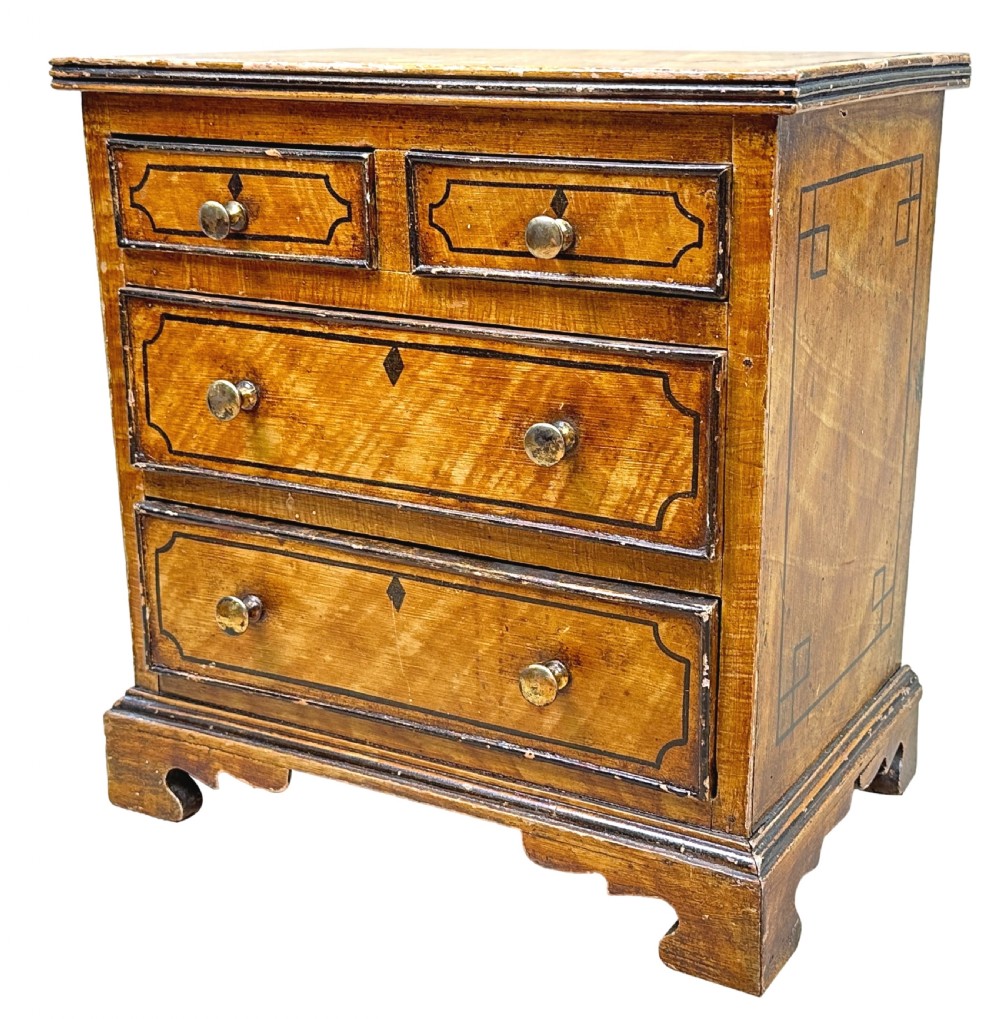 A 19th-century miniature pine chest of drawers with grain-painted finish, black line borders, and bracket feet. View II