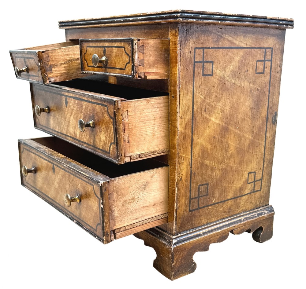 A 19th-century miniature pine chest of drawers with grain-painted finish, black line borders, and bracket feet. View IV