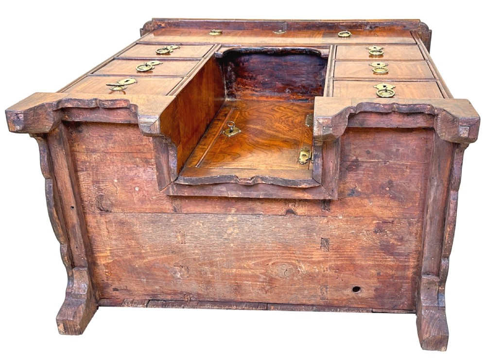 An 18th-century walnut kneehole desk featuring a long upper drawer, six small pedestal drawers, a central recessed cupboard, and brass drop handles on bracket feet. View XII