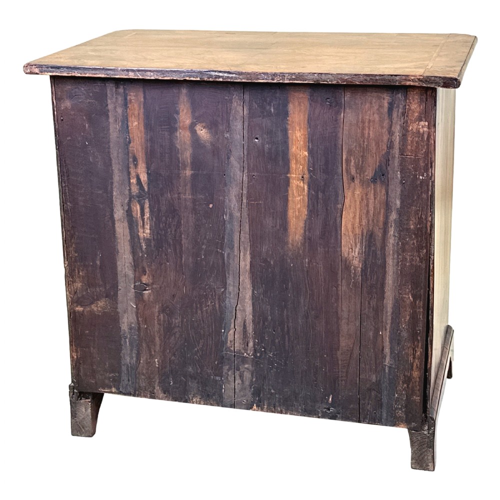 An 18th-century walnut kneehole desk featuring a long upper drawer, six small pedestal drawers, a central recessed cupboard, and brass drop handles on bracket feet. View XIII