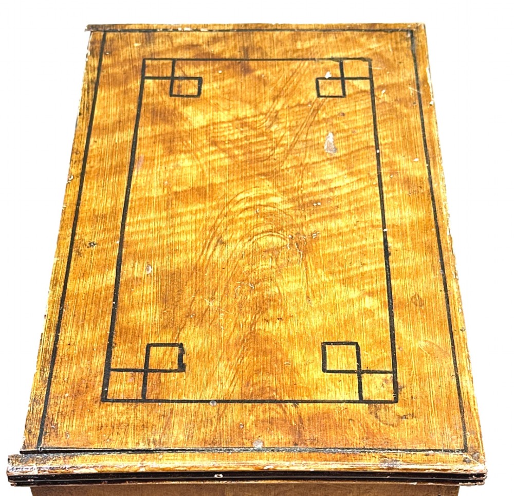 A 19th-century miniature pine chest of drawers with grain-painted finish, black line borders, and bracket feet. View X