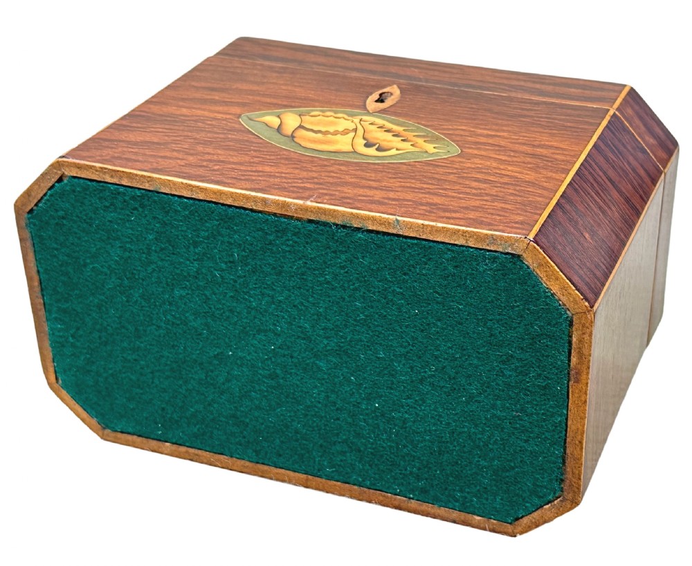 An octagonal wooden tea caddy in warm brown timber featuring marquetry shell inlays on the top and front panel with fine edge stringing. View IX
