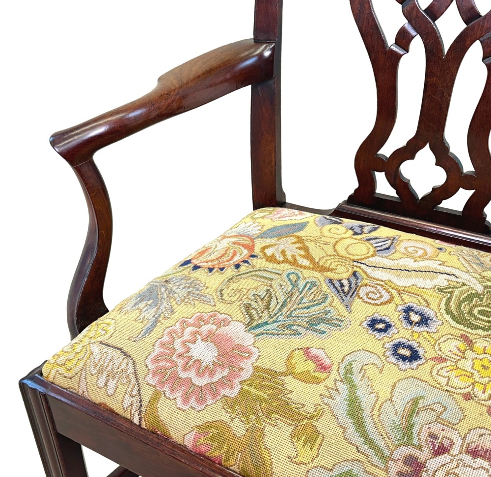 An 18th-century Georgian Chippendale mahogany armchair featuring a carved pierced back splat, shaped armrests, square legs, and a floral tapestry seat. View II