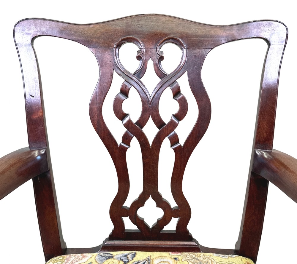 An 18th-century Georgian Chippendale mahogany armchair featuring a carved pierced back splat, shaped armrests, square legs, and a floral tapestry seat. View III