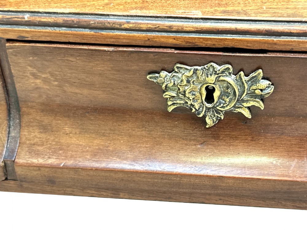 An antique Georgian mahogany toilet mirror featuring a pivoting arched glass frame set above a box base with three drawers and brass fittings. View V