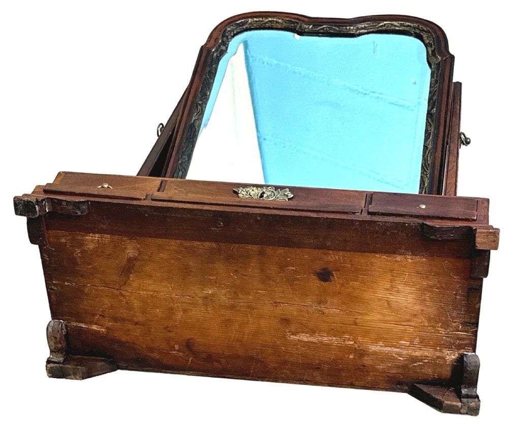 An antique Georgian mahogany toilet mirror featuring a pivoting arched glass frame set above a box base with three drawers and brass fittings. View X