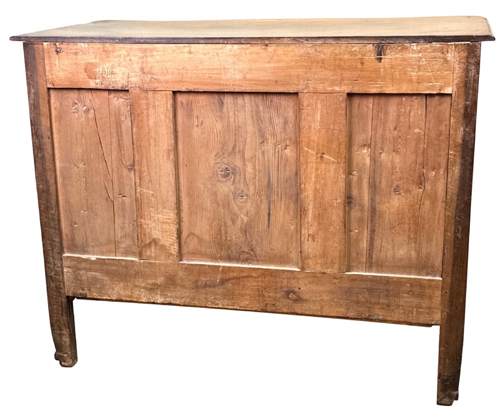 An 18th-century French provincial walnut commode chest featuring three full-width drawers decorated with elaborate brass handles and keyhole escutcheons, set above a scalloped apron and short cabriole legs. View XIV