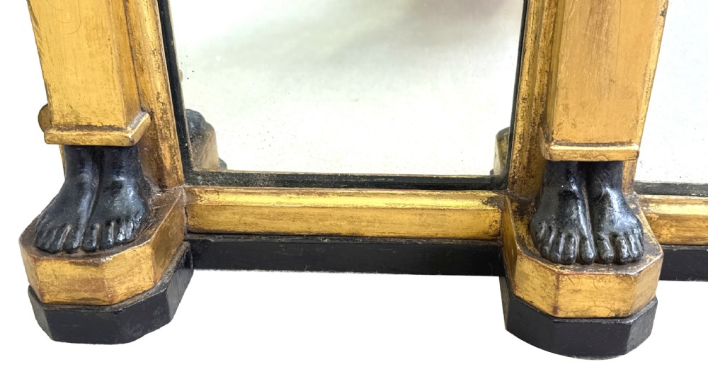A wide Regency giltwood overmantel mirror featuring three mirror plates, ball moulding along the top cornice, central carved shell frieze, and black Egyptian head pilasters. View V