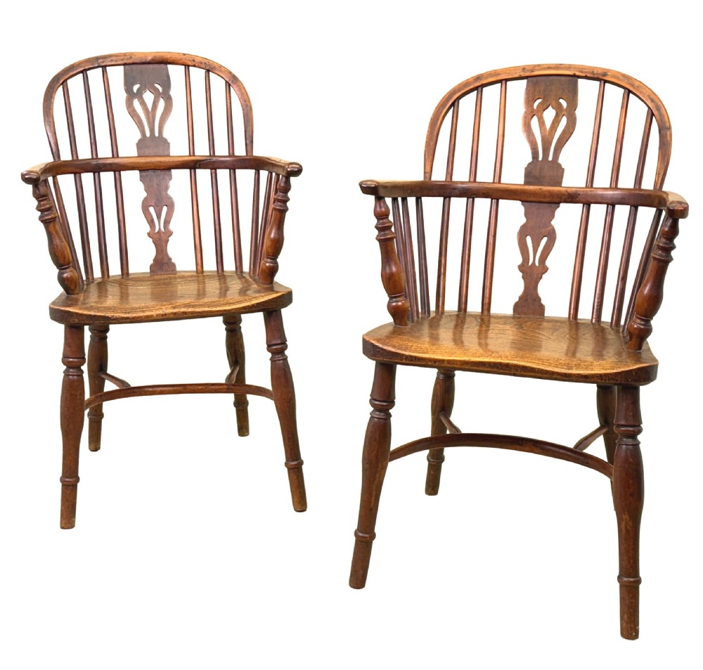 A pair of 19th-century yew wood Windsor armchairs featuring steam-bent hoop backs, pierced central back splats, turned spindle supports, and contoured saddle seats. View III