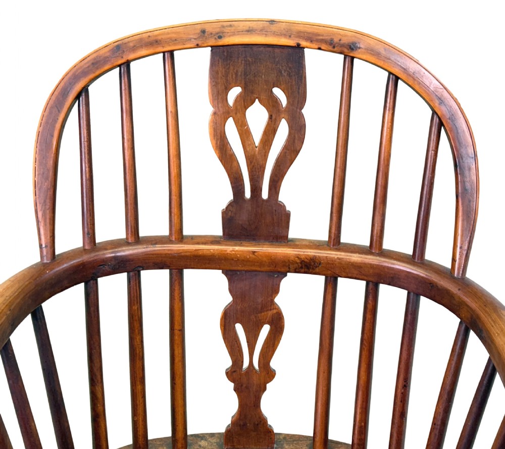 A pair of 19th-century yew wood Windsor armchairs featuring steam-bent hoop backs, pierced central back splats, turned spindle supports, and contoured saddle seats. View IV