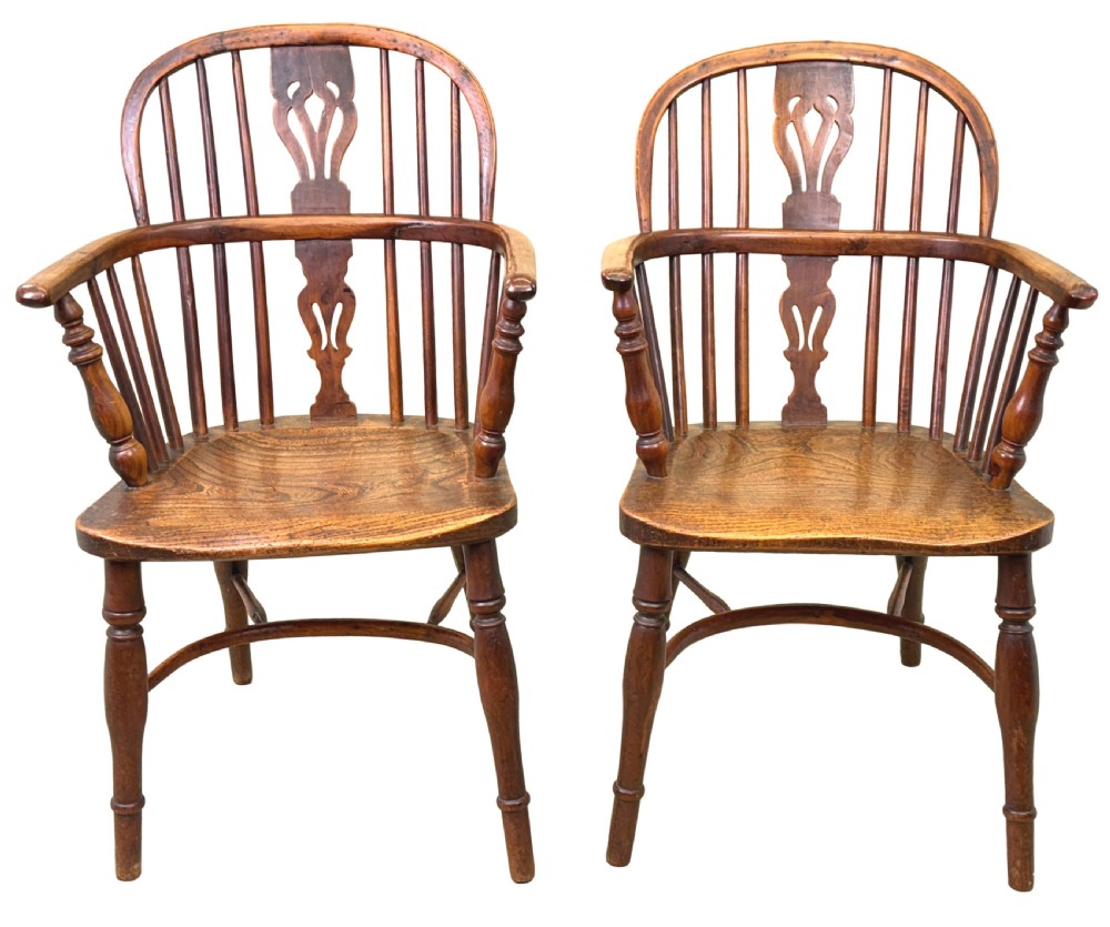 A pair of 19th-century yew wood Windsor armchairs featuring steam-bent hoop backs, pierced central back splats, turned spindle supports, and contoured saddle seats. View XIII