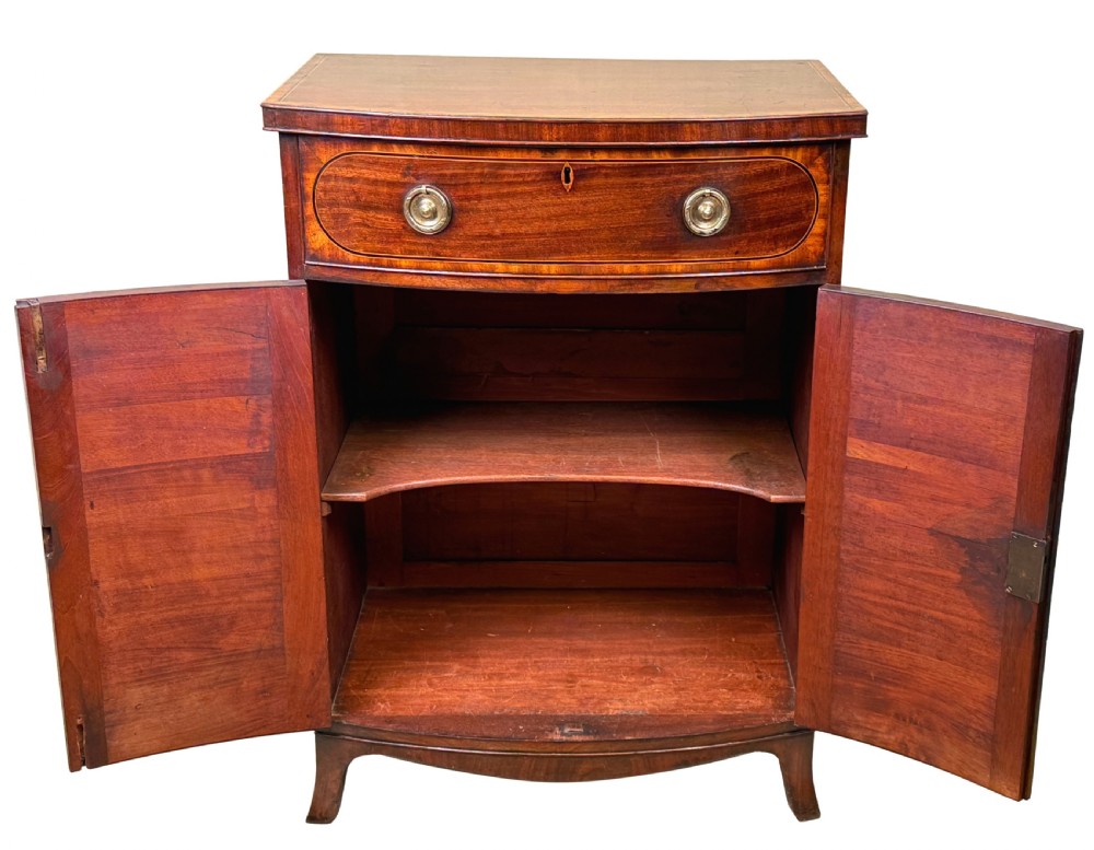 An 18th-century Georgian mahogany bowfront side cupboard featuring two arched inlaid doors, a top frieze drawer with brass handles, and splay feet. View III