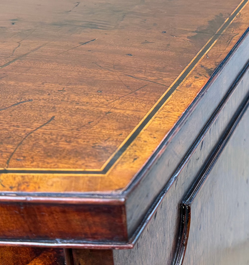 An 18th-century Georgian mahogany bowfront side cupboard featuring two arched inlaid doors, a top frieze drawer with brass handles, and splay feet. View IX