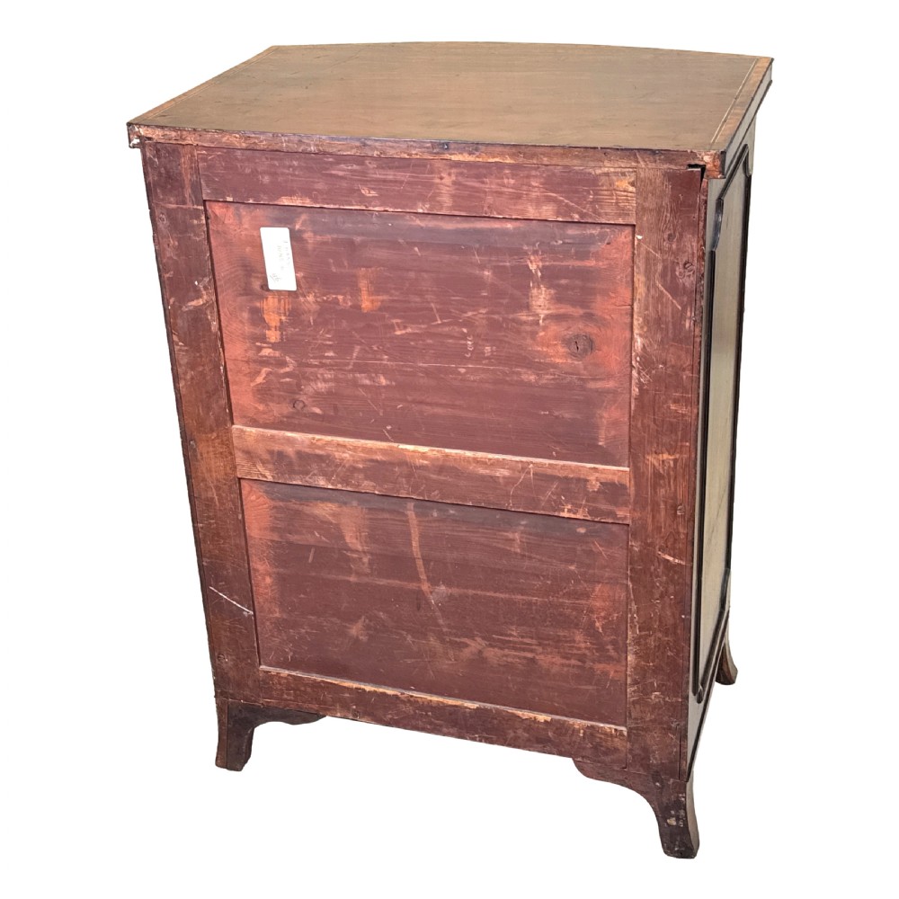 An 18th-century Georgian mahogany bowfront side cupboard featuring two arched inlaid doors, a top frieze drawer with brass handles, and splay feet. View X