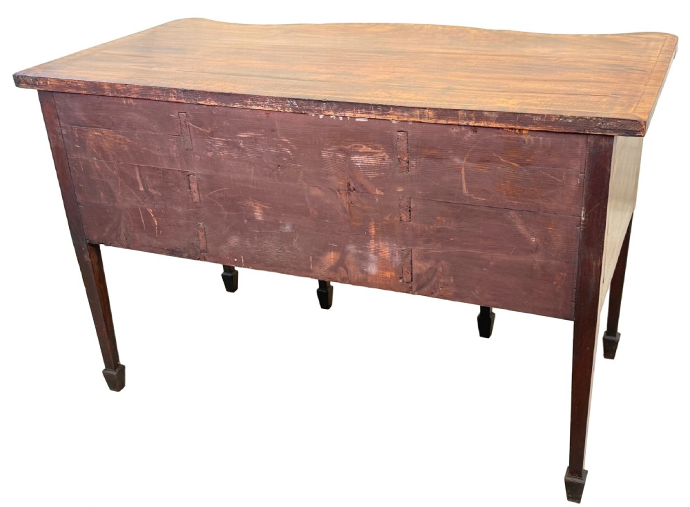 A small Georgian mahogany sideboard featuring a serpentine front, floral marquetry inlay, multiple drawers with brass ring handles, and tapered square legs with spade feet. View XIII